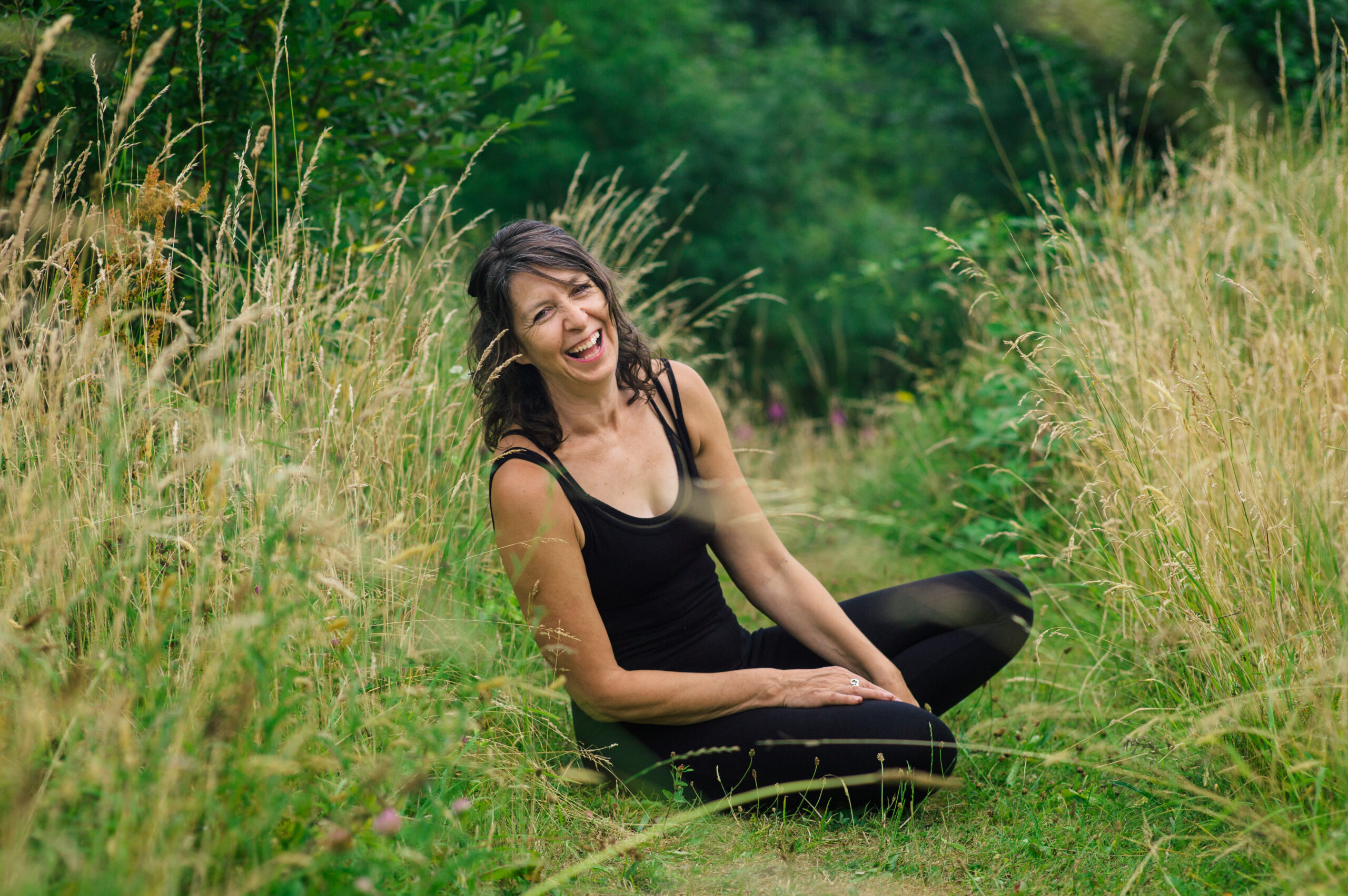 Jane sits in a grassy field